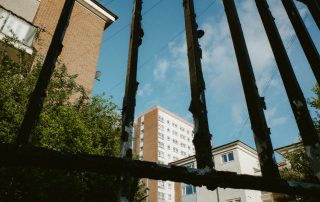 Urban flats seen through fence
