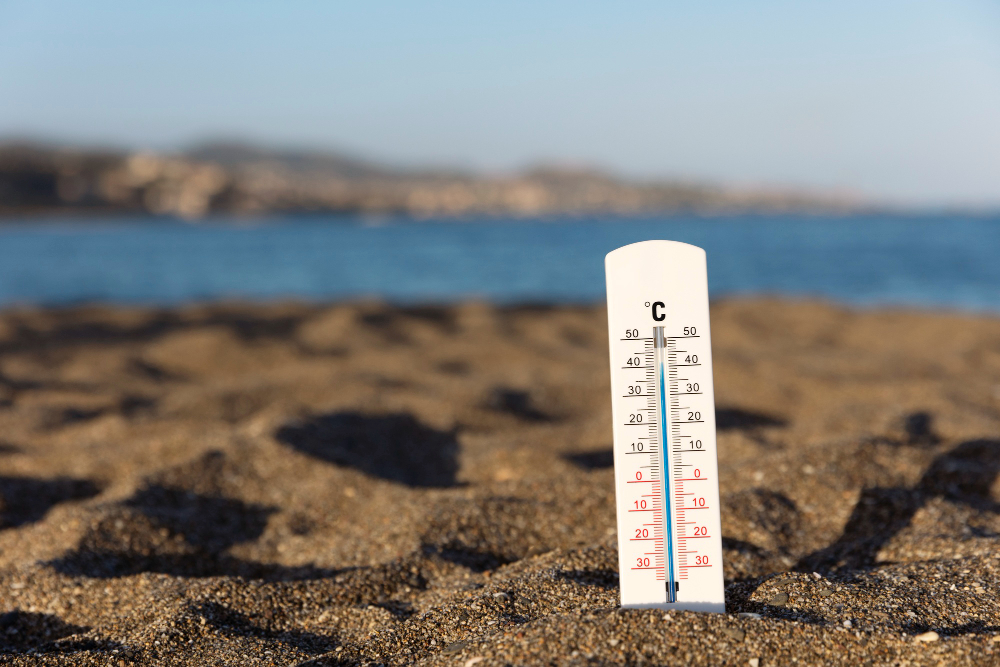 Thermometer in the sand on hot day Thermometer in the sand on hot day