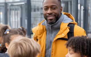 Friendly teacher welcoming diverse group students